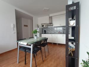 a kitchen and dining room with a table and chairs at La Casita de Héctor in Arinaga