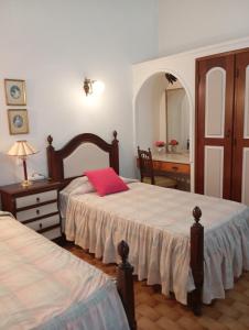 a bedroom with two beds and a dresser and a mirror at Villa Cristina e Ricardo in Carvoeiro +27 photos