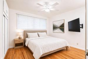 a white bedroom with a bed and a ceiling fan at MOUNTAIN WILLOW GETAWAY in Jackson