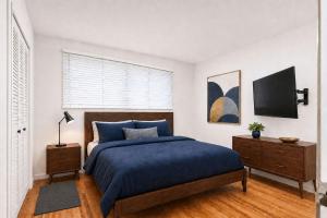 a bedroom with a blue bed and a window at MOUNTAIN WILLOW GETAWAY in Jackson