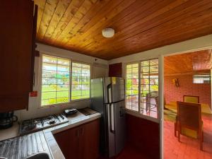a kitchen with a stainless steel refrigerator in a room at Chalet Natalia Montenegro Quindío in Montenegro