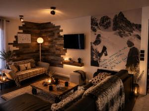 a living room with a couch and a table at Chalet Le Quartz in Val Thorens