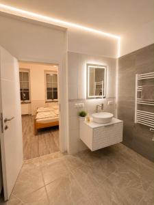 a bathroom with a sink and a bed in a room at Vacation Room in Traben-Trarbach