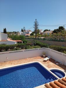 a swimming pool on top of a house at Villa Cristina e Ricardo in Carvoeiro