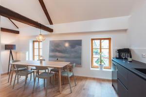 a kitchen and dining room with a table and chairs at Krebiehls Winkelhof in Herxheim am Berg