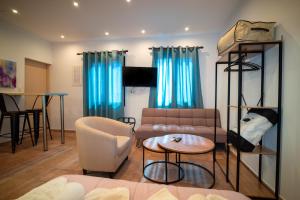 a living room with a couch and a table at Bungalow - Camping Apollon in Delphi