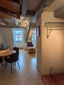 a room with a table and chairs and a dining room at Ferienwohnung Am Markt in Eisfeld