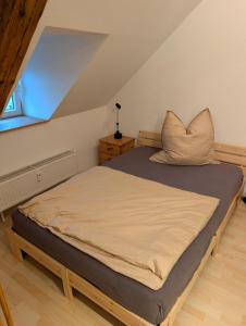 a large bed in a room with a window at Ferienwohnung Am Markt in Eisfeld +4 photos
