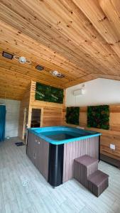 a swimming pool in a building with a wooden ceiling at PENSIUNEA TEOMIR in Pojorâta