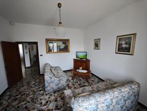 a living room with two couches and a television at Sosta FONTE DAVIDDI in Santa Fiora