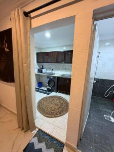 a view of a kitchen through a doorway at Bedroom Jimi in Al Ain