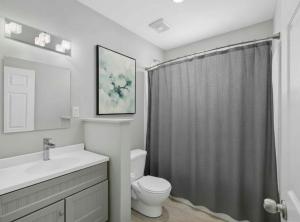 a bathroom with a toilet and a shower curtain at PEAK AND PINE GETAWAY in Eden