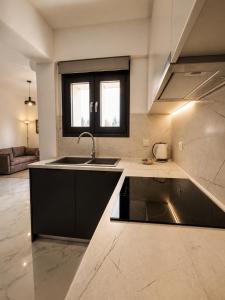 a kitchen with a sink and a stove at Skyloft Meteora 1 in Kalabaka +17 photos