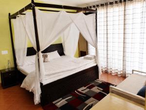 a bedroom with a bed with a canopy at Du Nepal Inn in Kathmandu