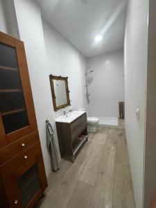 a bathroom with a sink and a toilet at Casa Capereta in Alberique