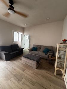 a living room with a couch and a table at Casa Capereta in Alberique +2 photos