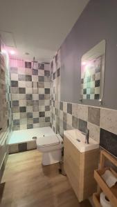 a bathroom with a toilet and a sink and a tub at hotel de Croix in Morlaix +34 photos