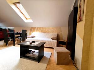 a living room with a couch and a table at Nebeski kutak in Valjevo