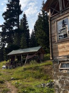 an old building in a field next to a forest at BBR House in Chʼkhakoura