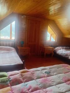 a bedroom with two beds and two windows at BBR House in Chʼkhakoura