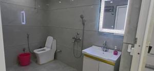 a bathroom with a shower and a toilet and a sink at Dev Palace in Saharsa