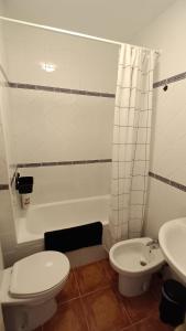 a white bathroom with a toilet and a sink at Casa María in Mojácar +13 photos