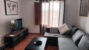 a living room with a couch and a flat screen tv at Casa María in Mojácar