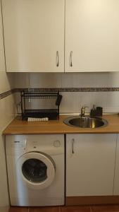a kitchen with a washing machine and a sink at Casa María in Mojácar