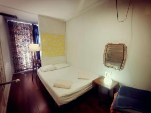 a small room with a bed and a mirror at Adventure Alternative - GUEST HOUSE - Arts-Factory-Experience - For artists, makers and open minds - Attention, we are not a hotel and are not adapted for everybody - Read host warnings before reservation - PROVIDENCE,BE asbl in Charleroi