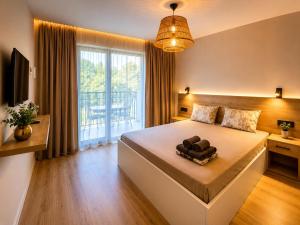 a bedroom with a large bed and a large window at Black Sea Pearl in Krapets