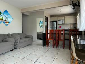 a living room with a couch and a table at Aluguel casa Bombinhas in Bombinhas