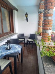 a patio with tables and chairs next to a building at Glicine in Carlazzo +10 photos