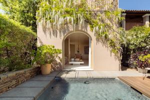 a house with a swimming pool in a yard at MUSE Saint Tropez - Small Luxury Hotels of the World in Saint-Tropez