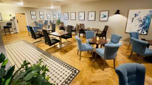 a restaurant with tables and chairs in a room at Cabarfeidh Hotel in Stornoway