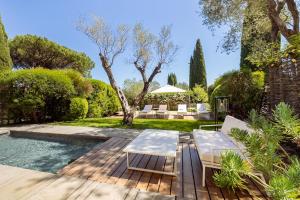 a garden with a table and chairs and a pool at MUSE Saint Tropez - Small Luxury Hotels of the World in Saint-Tropez +59 photos