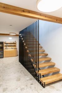 a staircase in a room with a black railing at Weingut Peter Grill in Leutschach