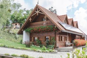 a wooden house with a thatched roof at Weingut Peter Grill in Leutschach