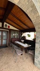a patio with a table and chairs in a building at PENSIUNEA TEOMIR in Pojorâta