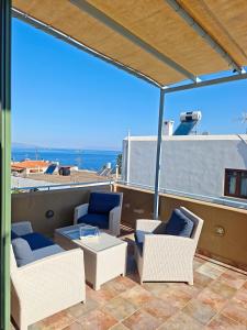 a balcony with chairs and a table on a boat at KLIMA apartment in Perdika