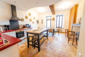 a kitchen and dining room with a table and chairs at L Ancestral in Beaumont-les-Autels