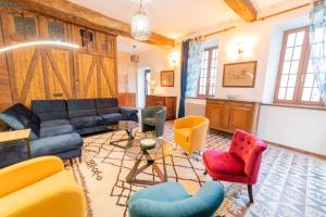 a living room with a couch and chairs at L Ancestral in Beaumont-les-Autels