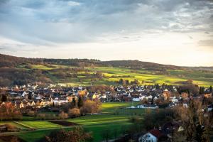 a small town in the hills with houses and trees at Frankenstube in Eichelsdorf