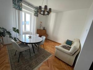a living room with a glass table and a couch at Boka view Heritage Apartment in Herceg-Novi +54 photos