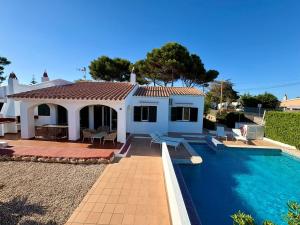 a villa with a swimming pool and a house at Villa Gabriela - piscine privée proche Punta Prima in Punta Prima