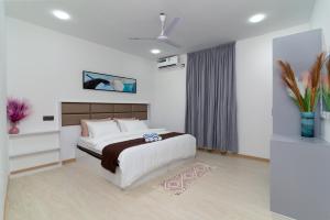 a bedroom with a large bed and a window at Nest and nook in Ukulhas