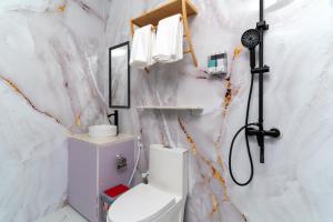 a bathroom with a toilet and a shower at Nest and nook in Ukulhas
