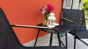 a black table with a vase of flowers on it at Crotto bedroom in Argegno