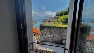 a view of a river from a room with a window at Crotto bedroom in Argegno