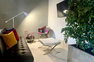 a living room with a couch and a chair at Signature Design & Panoramic Views in Montecatini Terme +36 photos