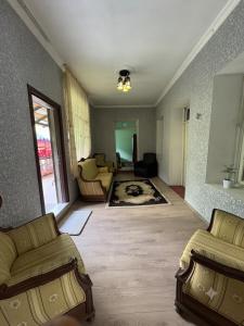a living room with two couches and a living room at Guest House Nino in Mestia